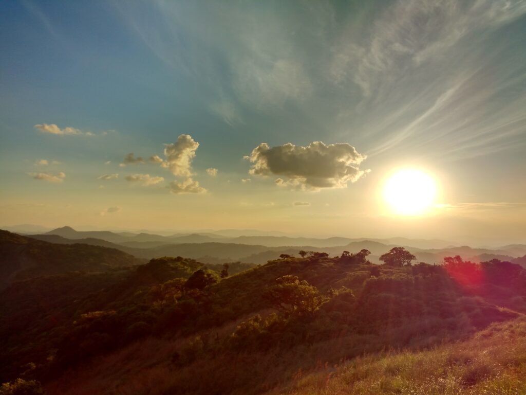 a sun setting over a mountain